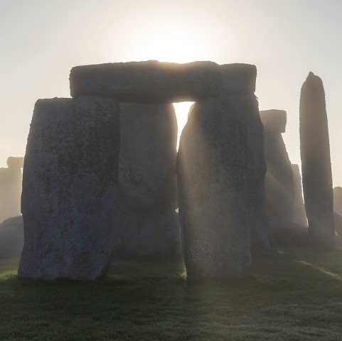 Image: Close-up photo of Stonehenge with the sun shining through the stones